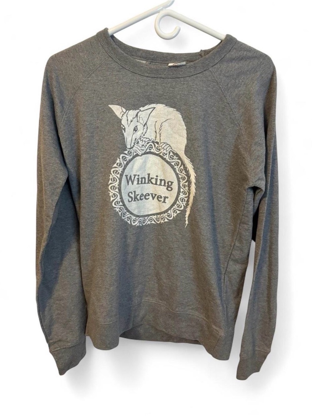 Delta Gray Crewneck Sweatshirt with Winking Skeever Illustration